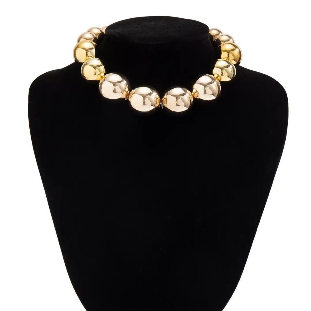 Golden punk choker necklace with oversized geometric spheres, made from 316L Stainless Steel, bold and edgy fashion accessory